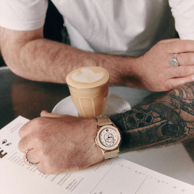 Montre Beaubleu Ecce Lys équipée du bracelet Flat White à côté d’un café latte