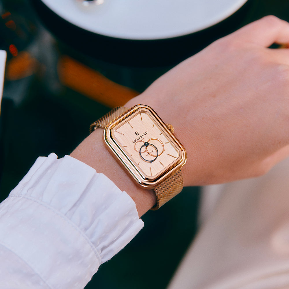 Montre Ecce Figura Sienna avec un cadran en acier brossé or rose porté au poignet d'une femme